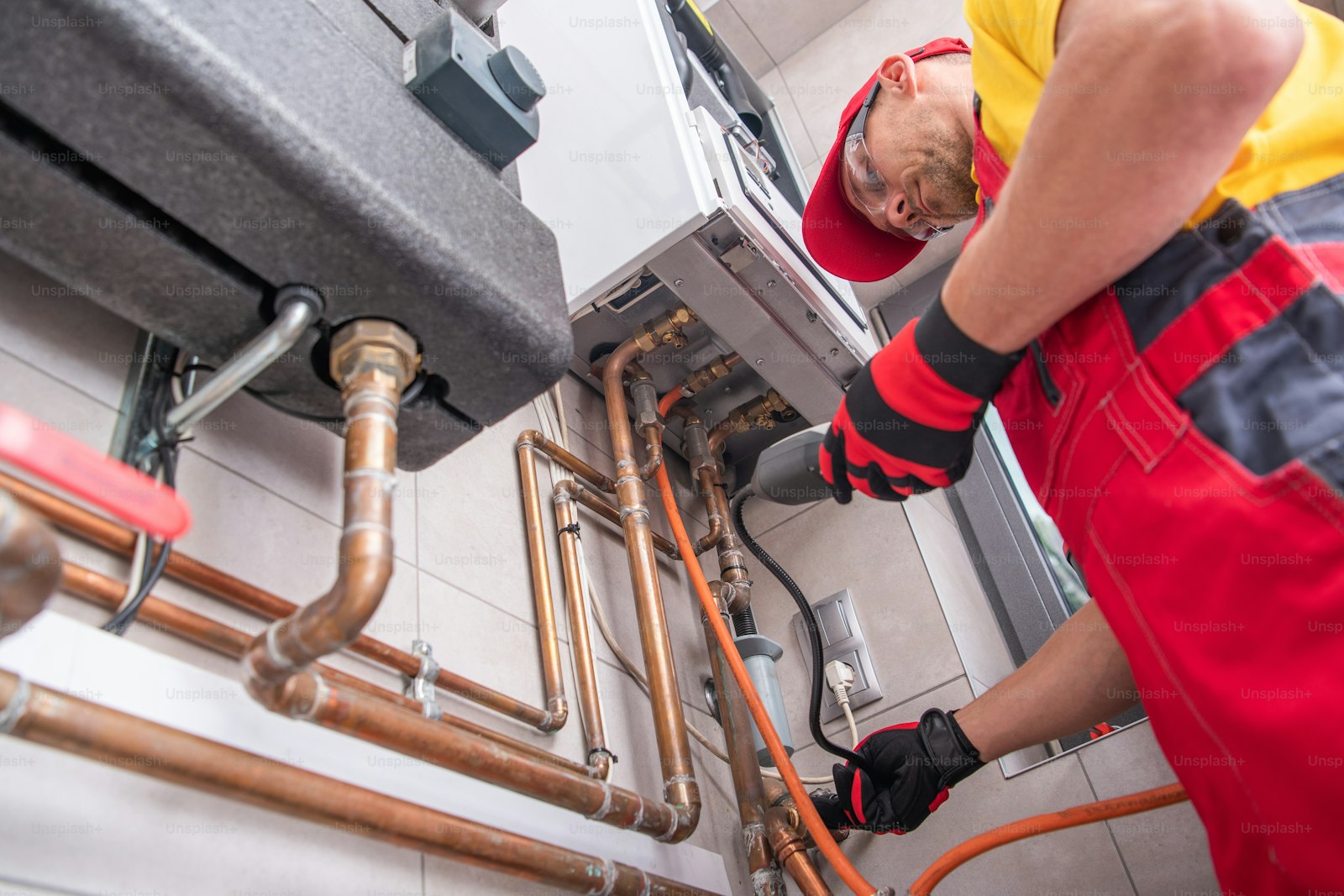 Professional plumber working in a Eastbourne home